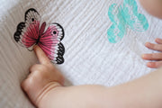 pointing to pink butterfly on the muslin swaddle 