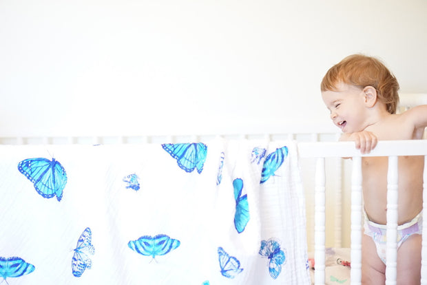 butterfly swaddle hanging on crib 