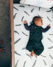 fitted crib sheet with baby in crib