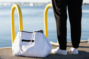 white diaper tote bag by water  